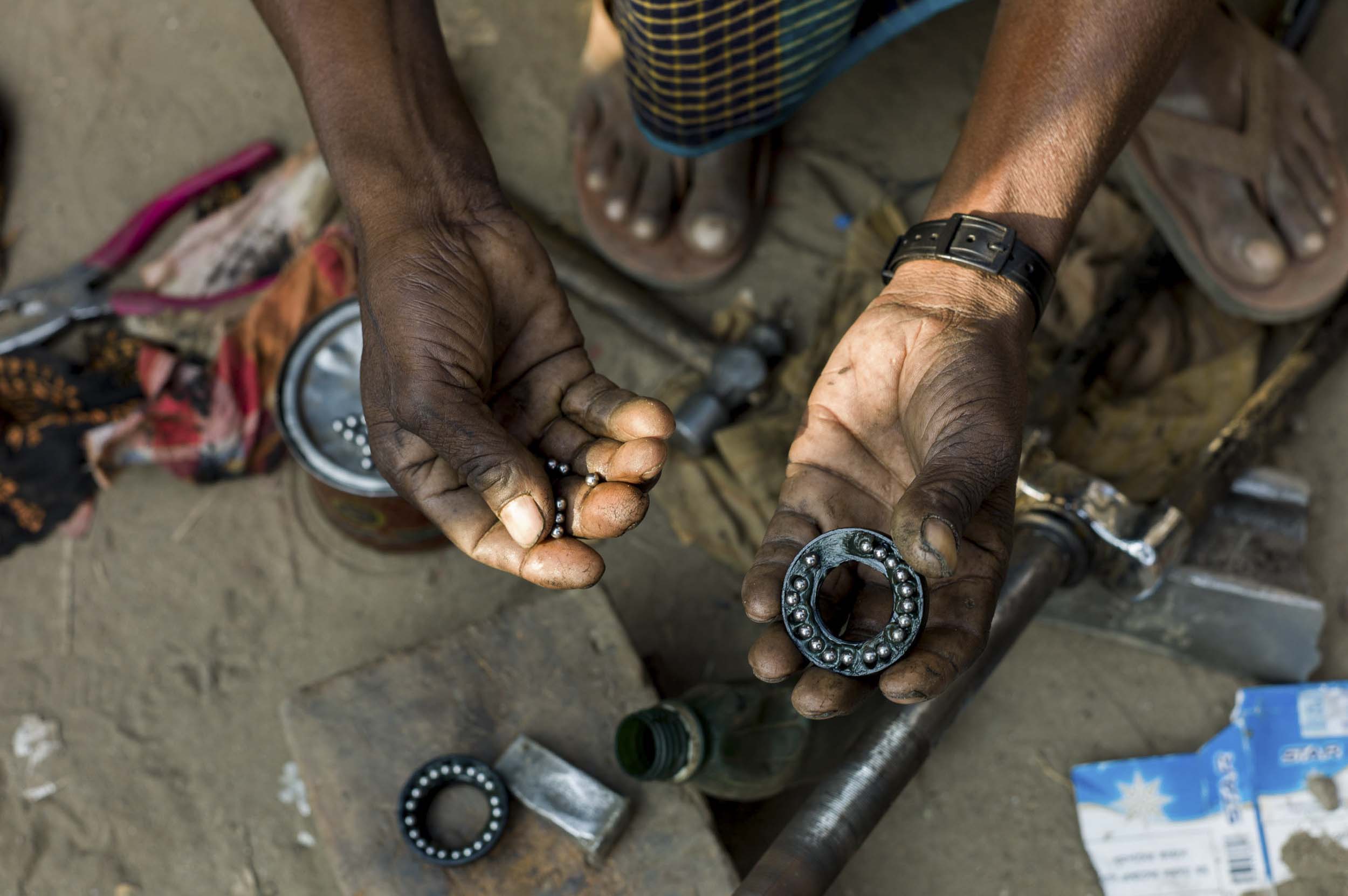A bicycle mechanic at a livery in a Dhaka slum, 2012