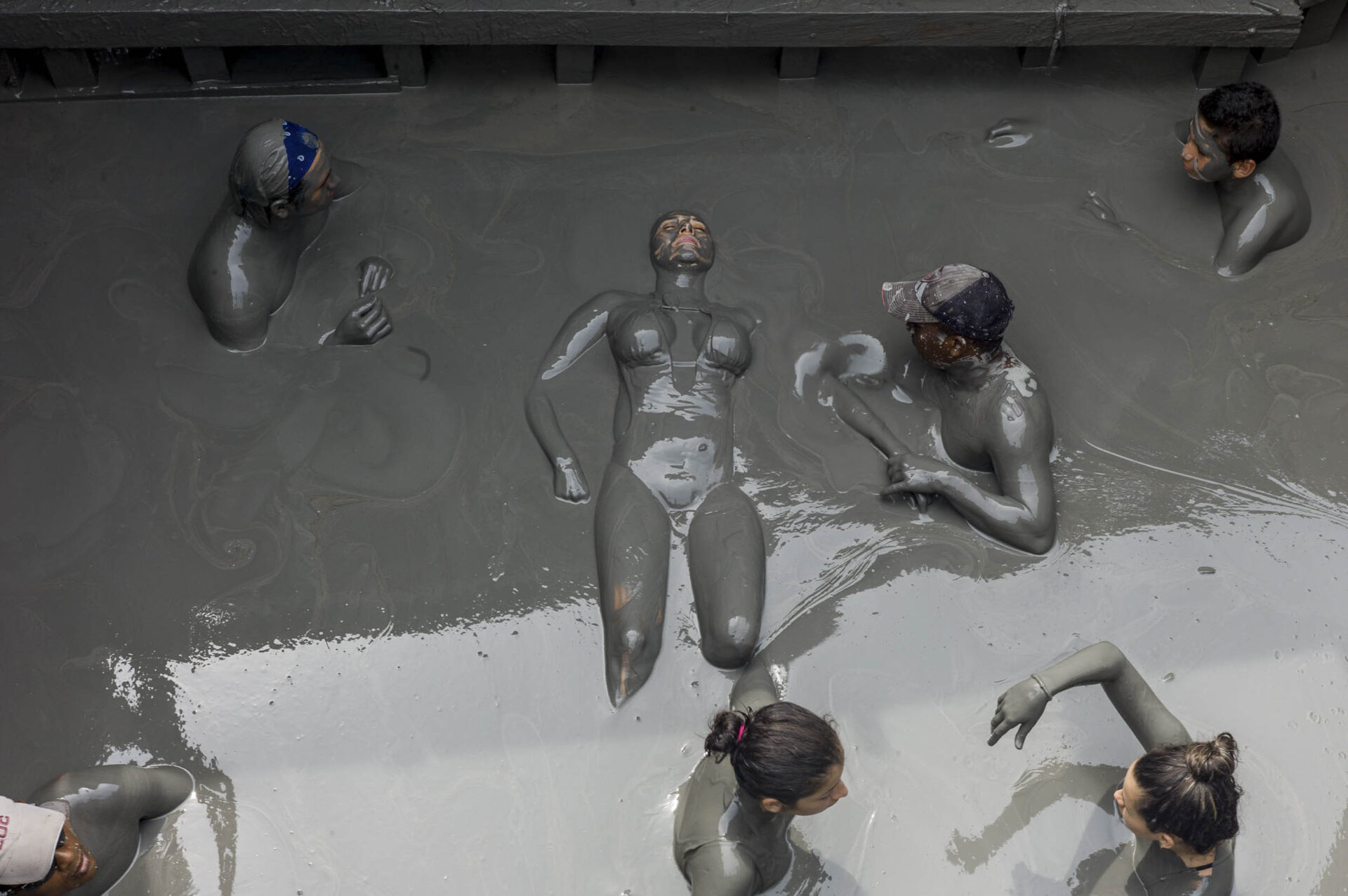 A tourist gets a massage at the Volcan de Lodo El Totumo. Located about 50-kilometers from Cartagena, this mud volcano bubbles bath-temperature water, 2014
