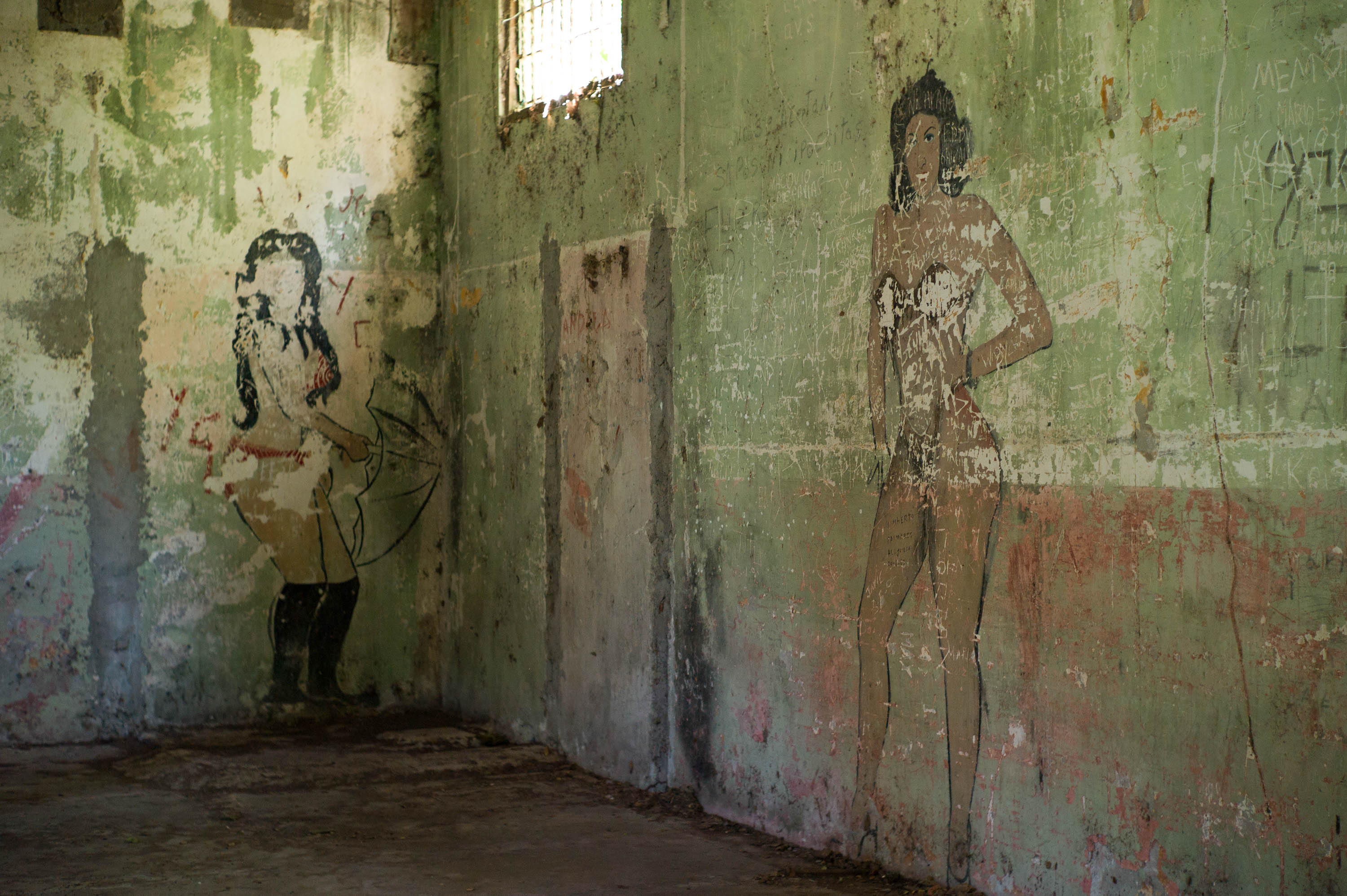 Inside a medium security cell. "The Woman in the Red Bikini," and "La Chica Consuelo" are the prison’s most notorious murals. In the 1960s or ’70s, a prison nurse was raped in the dispensary by an inmate who escaped this cell. Other inmates followed and 75 prisoners ended up raping the victim before her violent death. After she was dead, a prisoner cut off her breasts and removed her liver. The bloody pieces were given to the artist who drew the infamous picture using her blood for the bikini top and bottom. Notice her hands. The artist, whose images adorn cell walls throughout the prison, could not draw hands