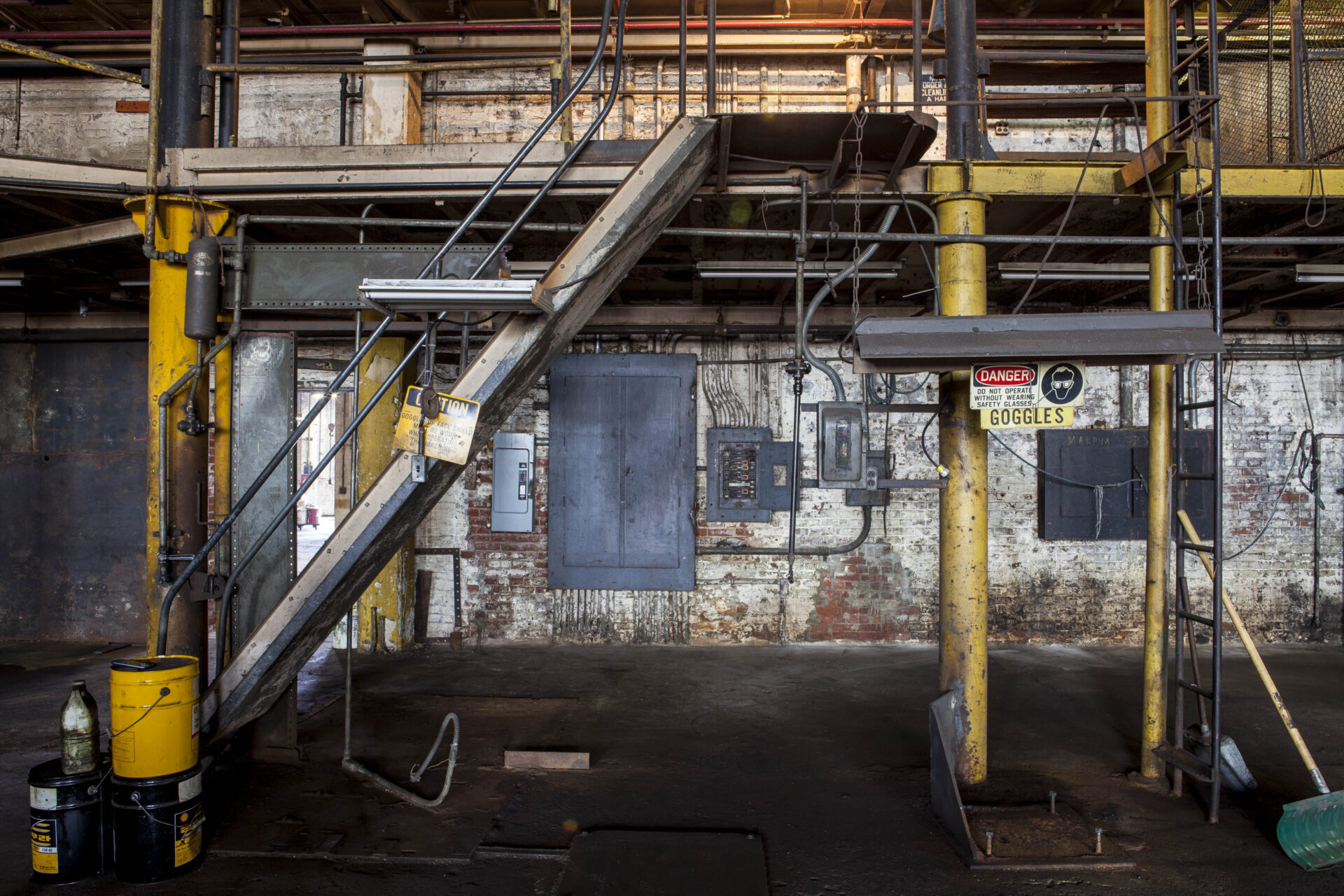Years of grease and grit cover an empty Goltens workshop