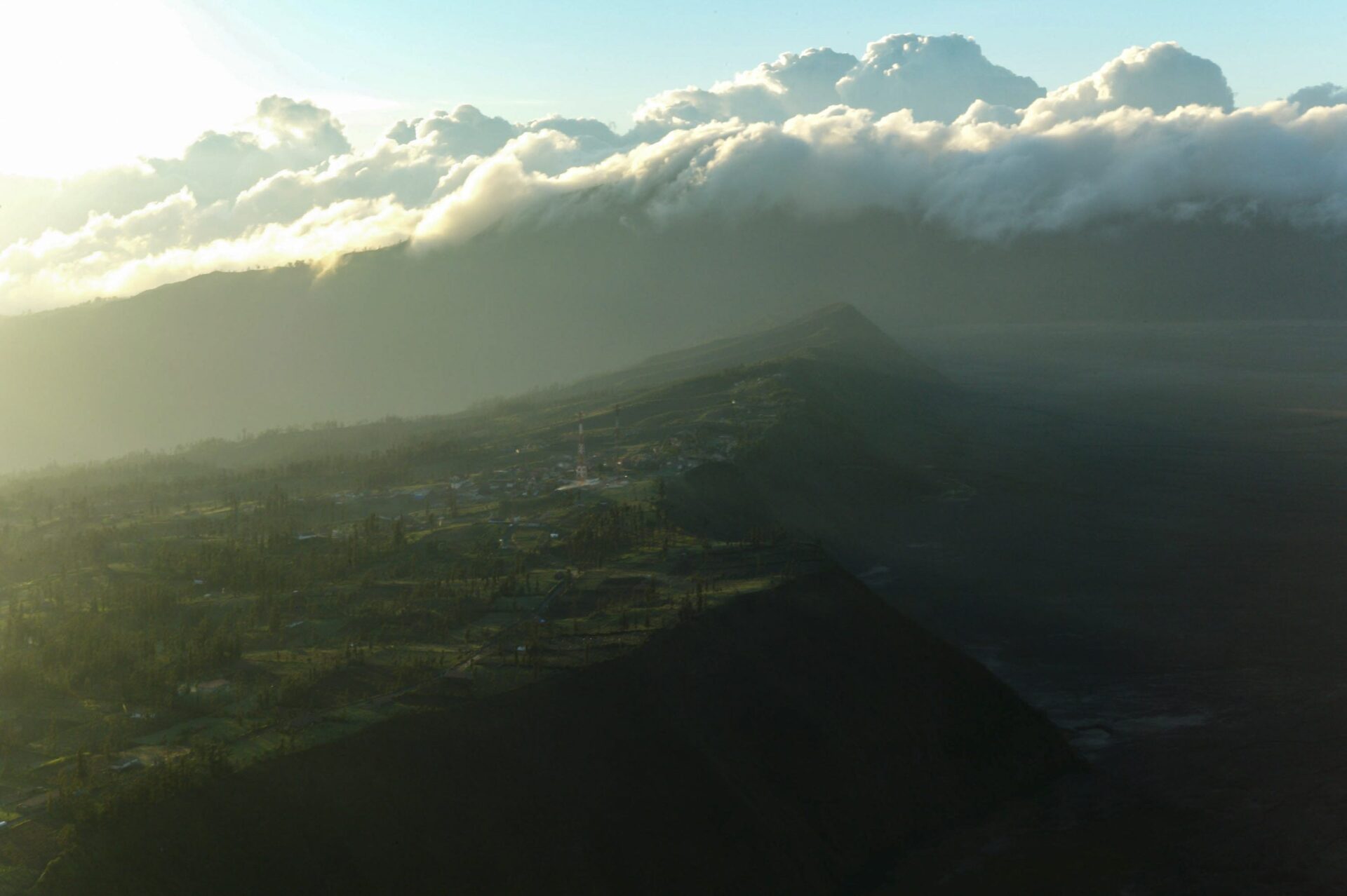 Sunrise on the crater edge of Bromo Volcano. The crater is 300m deep and a sheer drop to its bottom where smoldering, Gunung Bromo (2329m) still churns, 2011