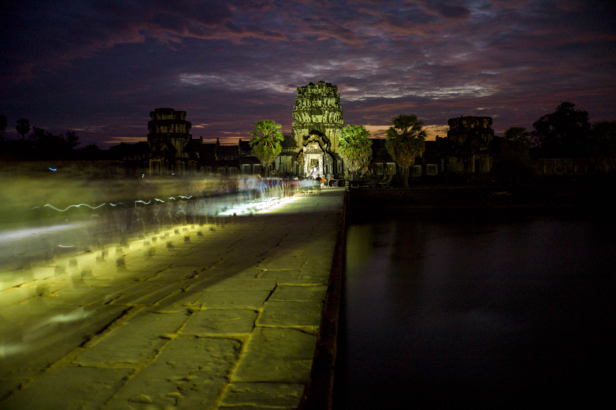 Tourist flashlights illuminate Angkor Wat at sunrise, 2012