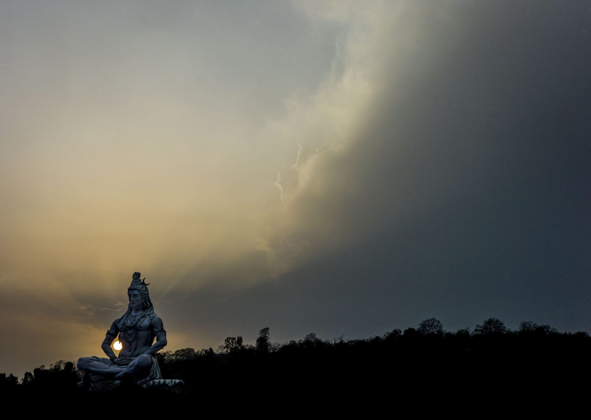 The sun sets through a statue of Shiva, Rishikesh, 2012