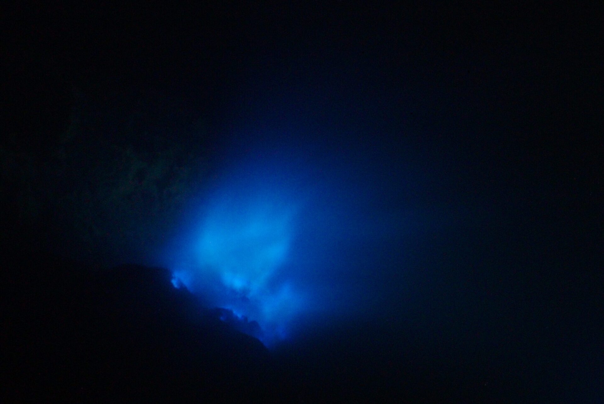 Blue flames from burning liquid sulfur in the Ijen volcano crater