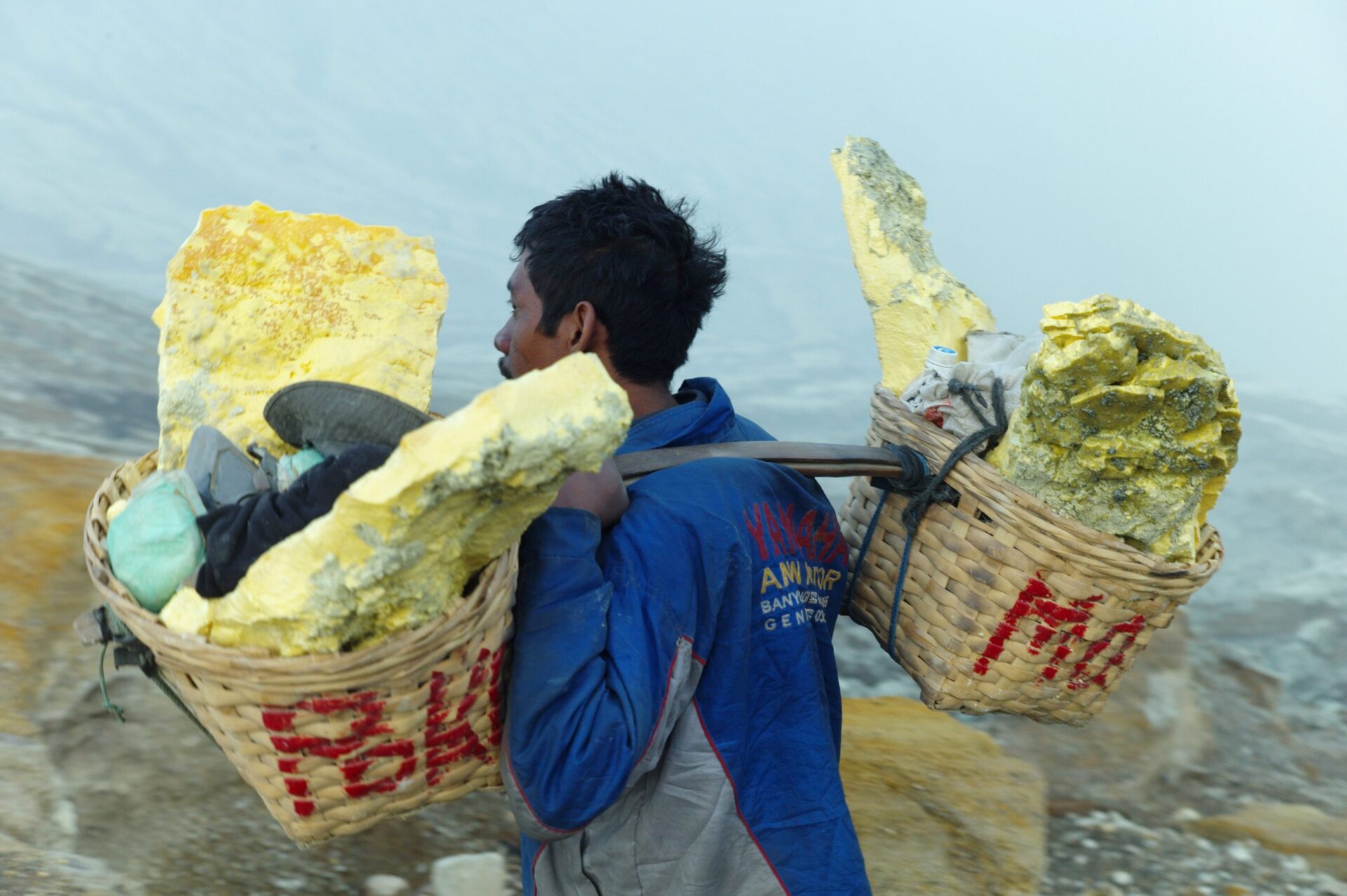 A miner hauling a load of raw sulfur