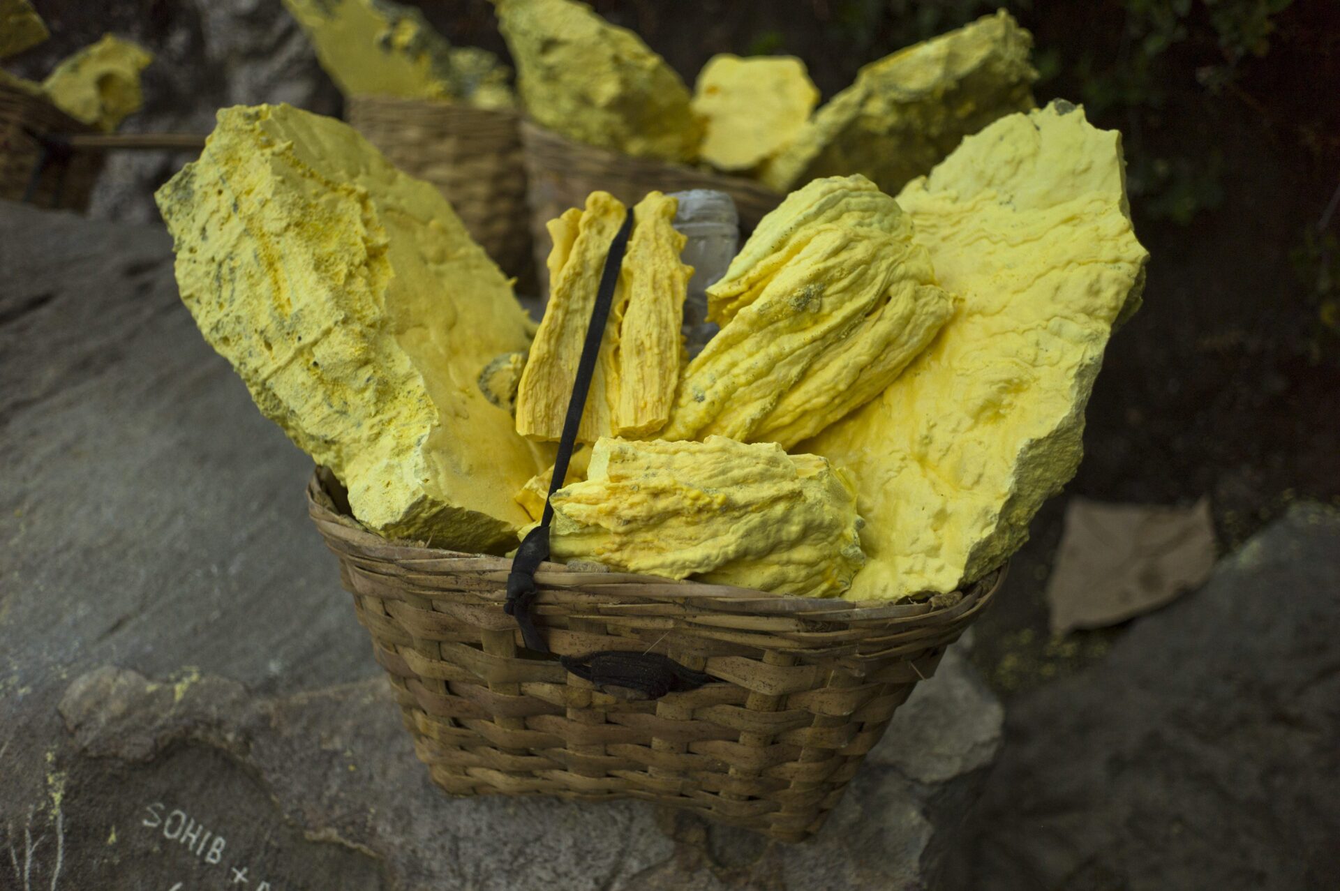 Raw mined sulfur awaits transfer to the bottom of the volcano