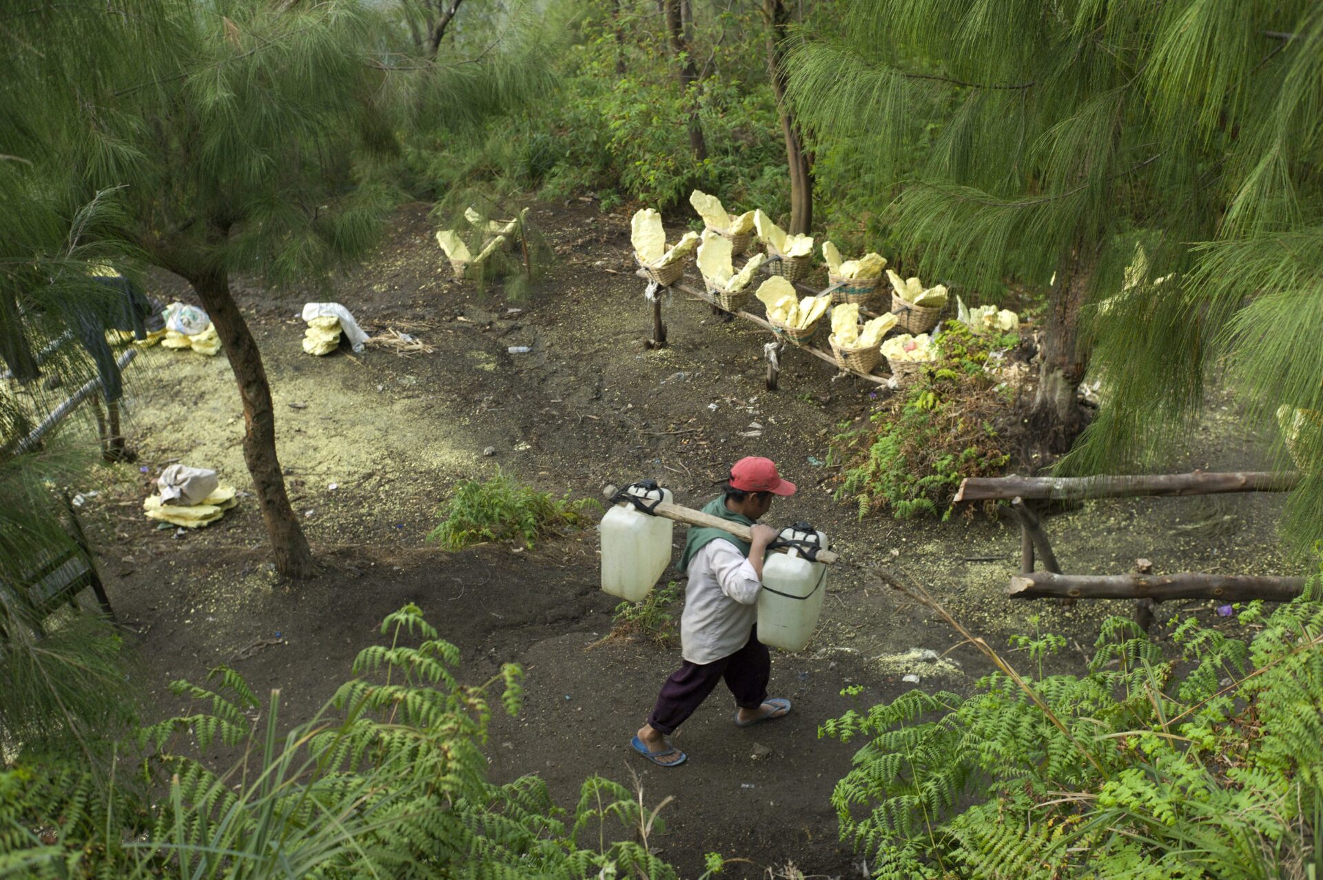 Baskets of raw sulfur await processing at the Ijen volcano