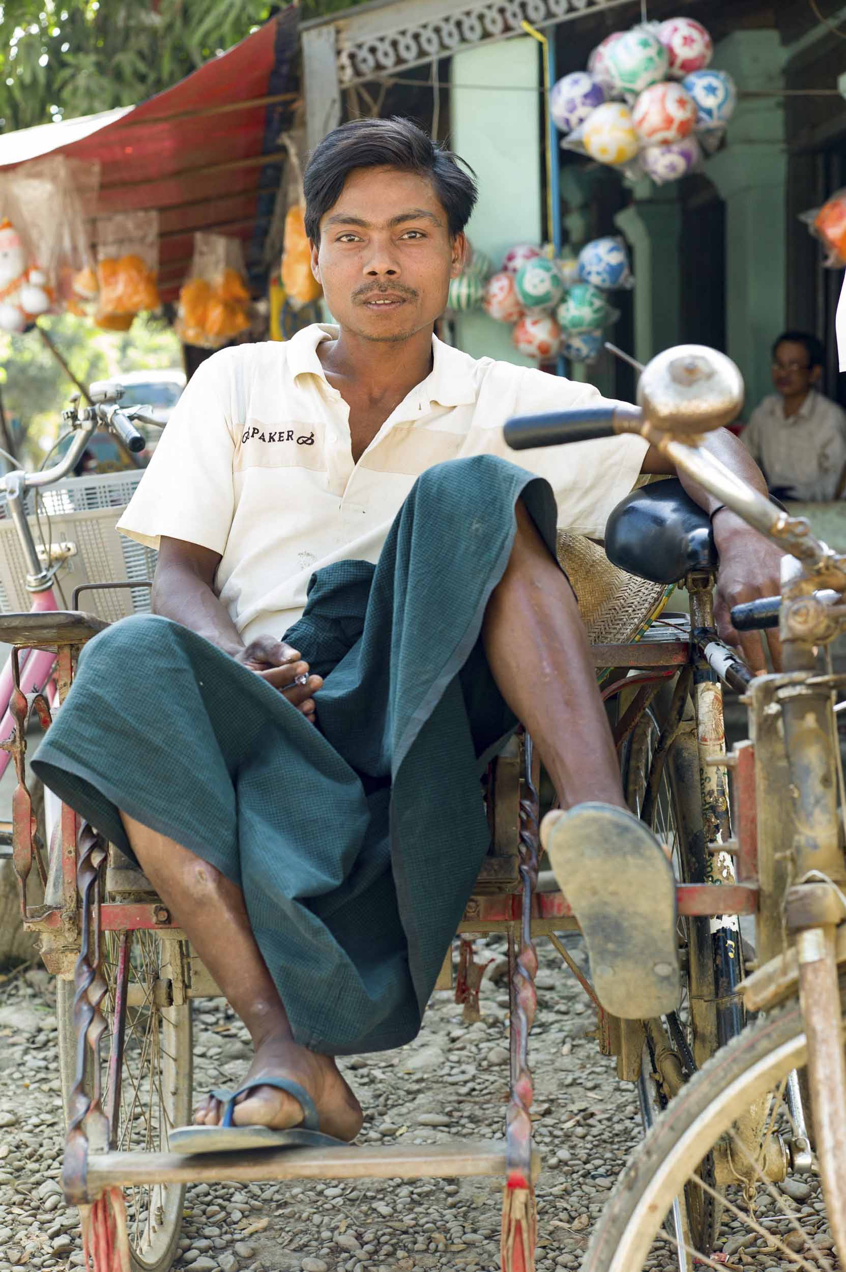 A bicycle rickshaw driver in Thonggok, a small village in western Myanmar, 2012