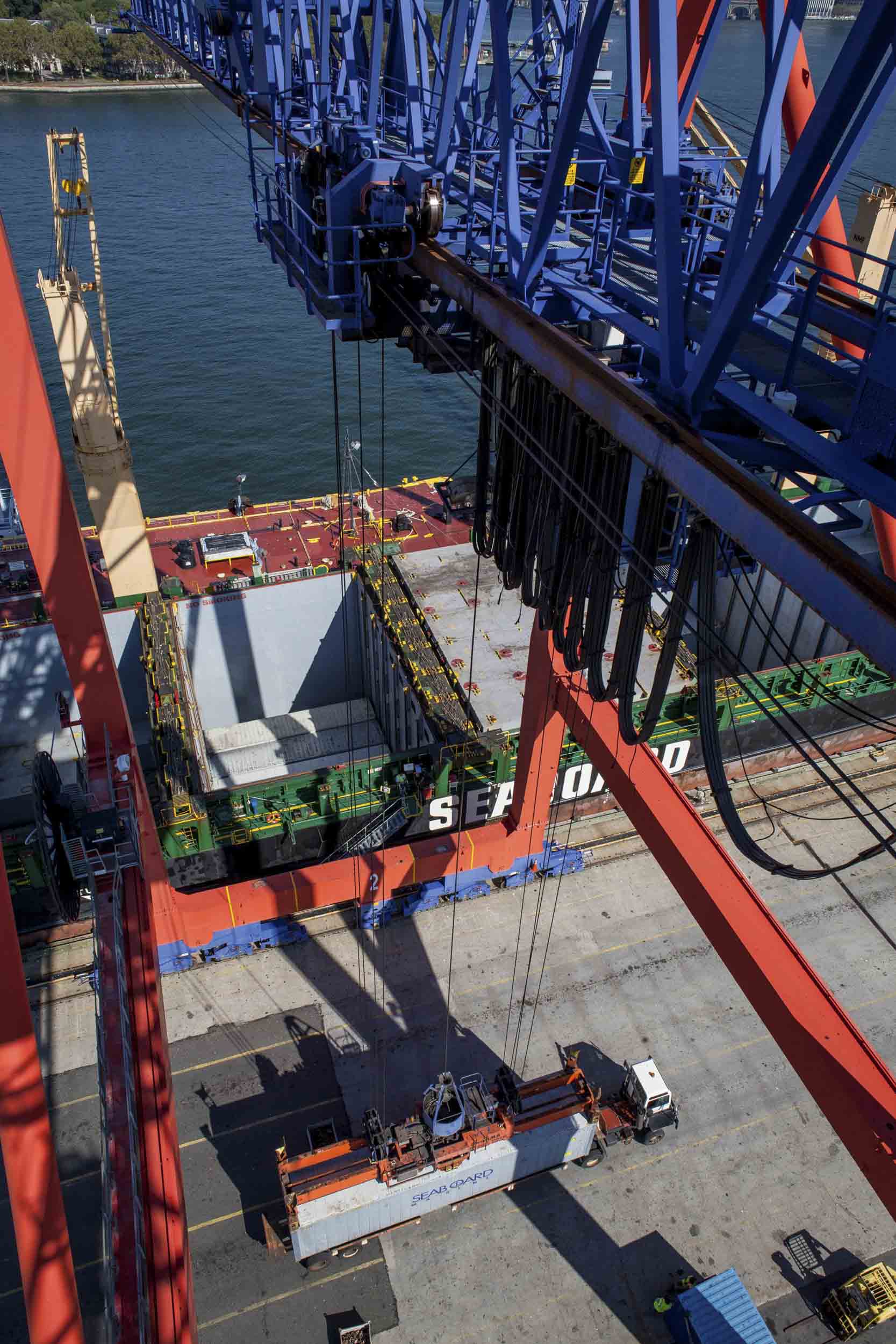 The crane loads a Tico Yard Tractor with a recently-arrived container