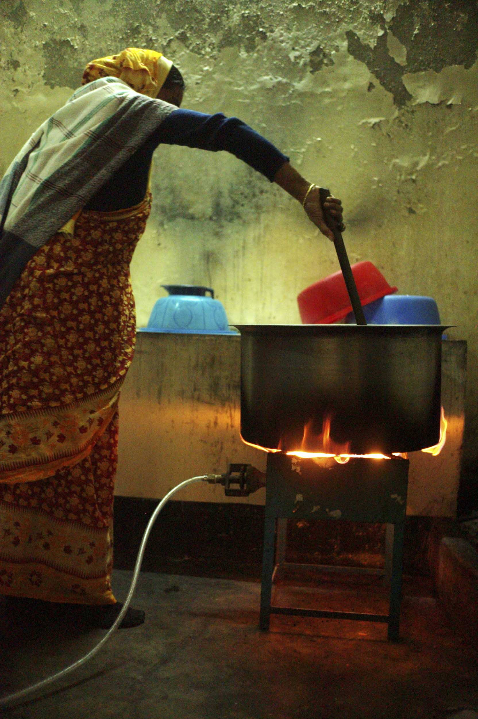 A school cook prepares a meal of vegetables and lentils, which for some students could be their only daily meal