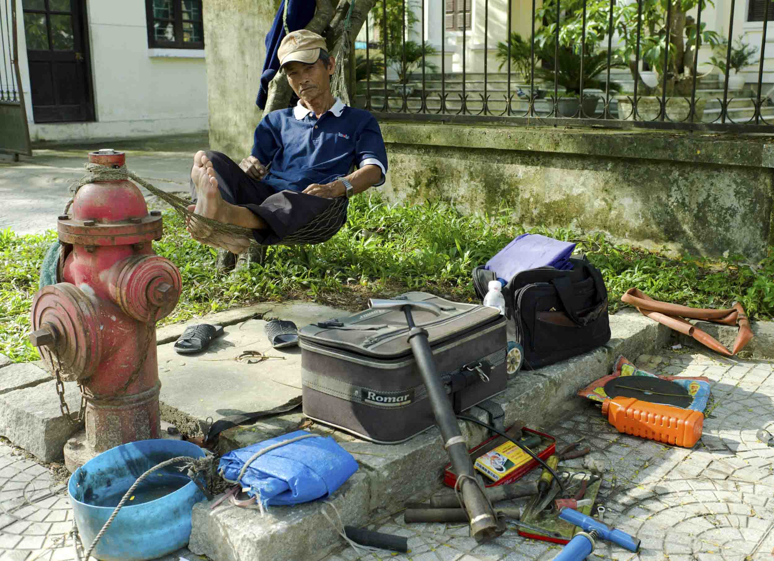 A street side bicycle and motorbike mechanic in Hue, an imperial city with a massive fort, 2011